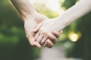 Couple holding hands - engagement evidence concept for fiance visa