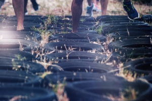 Low section of people receiving tire obstacle course training