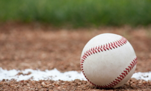 Close-up of a baseball sitting near the foul line