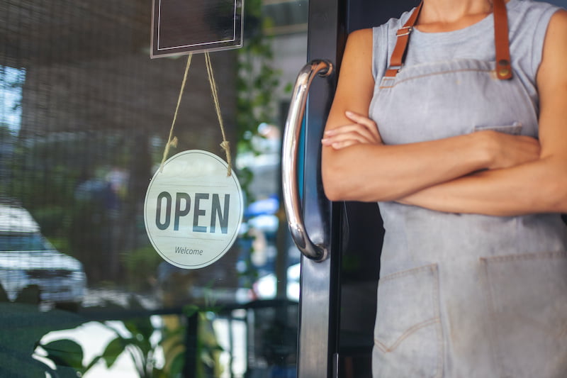 small business owner in front of her store - dba concept