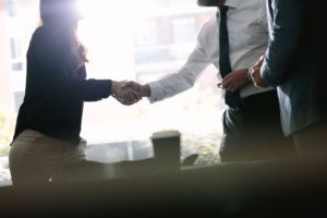 Business associates shaking hands after a deal in meeting. Business people hand shake and greeting each other after an agreement.