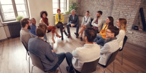 Business people talking at group meeting in circle