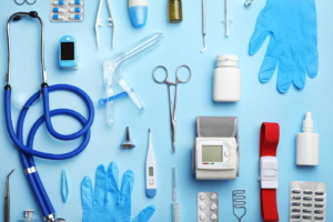 Medical Emergency Concept: Medical tools laying on a light blue background.