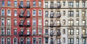 New York City historic apartment building panoramic exterior view with windows and fire escapes
