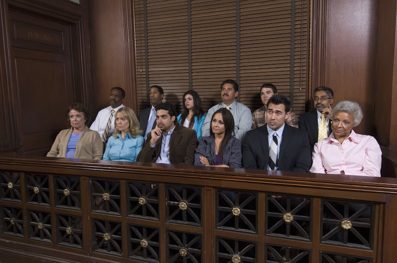 jurors in the jury box, watching a case unfold.