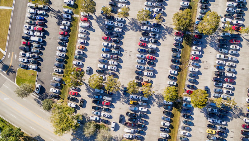aerial overhead view of big and crowded car parking.
