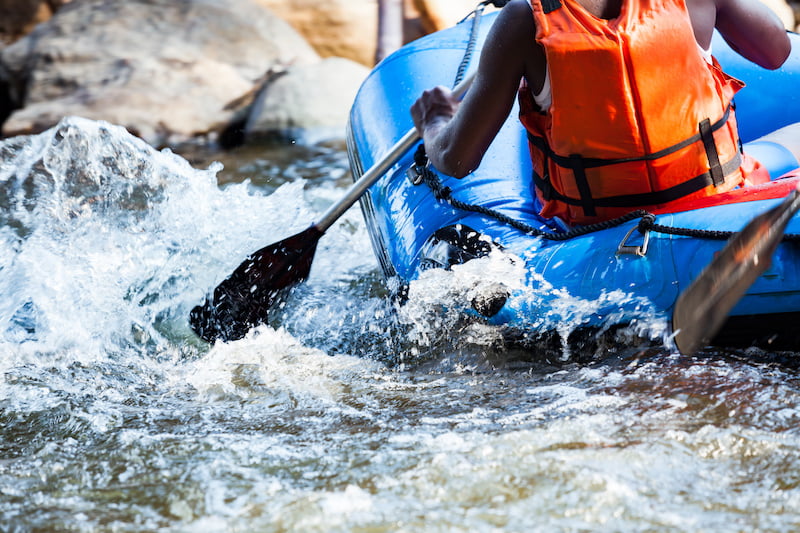 close-up of young person rafting on the river, extreme and fun sport at tourist attraction