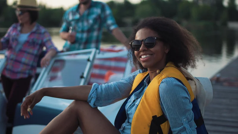 woman posing while partying with friends on boat.