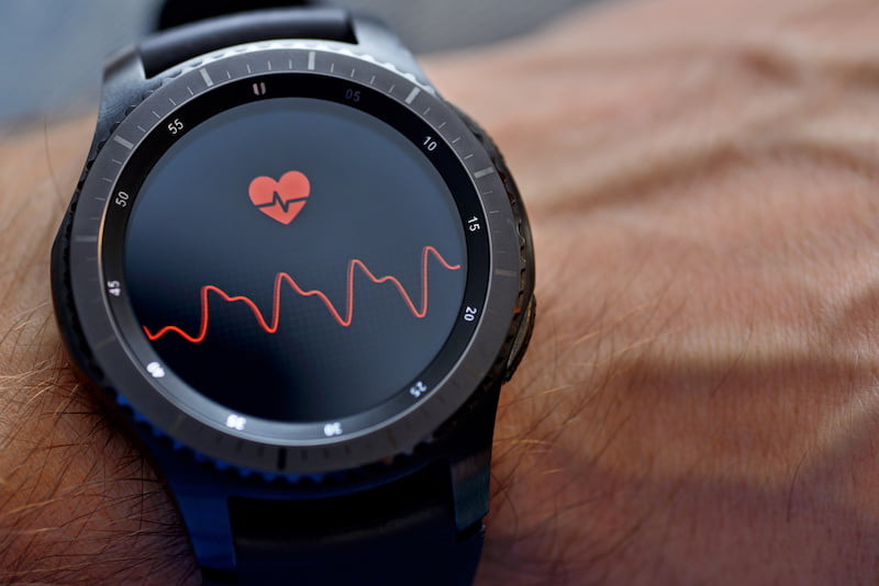 smartwatch on a man's wrist, heart on face.