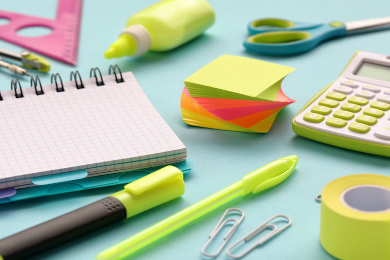 stationery and office supplies on a blue paper background