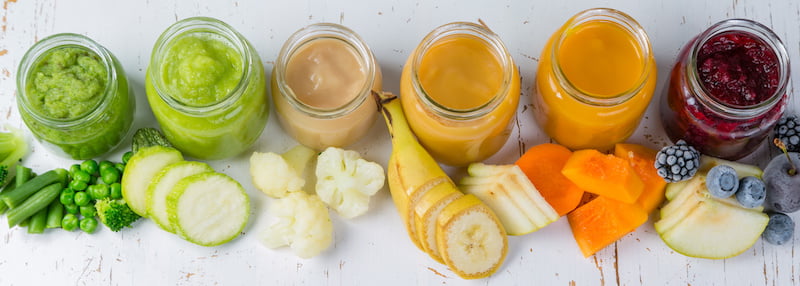 colorful baby food purees in glass jars with ingredients. healthy organic baby food concept. starting solid food, delivery