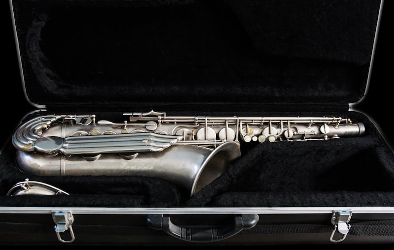 silver saxophone in its case