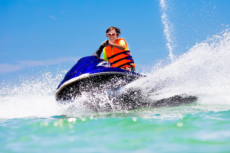 teenager on jet ski. teen age boy skiing on water scooter. young man on personal watercraft in tropical sea. active summer vacation for school child. sport and ocean activity on beach holiday.