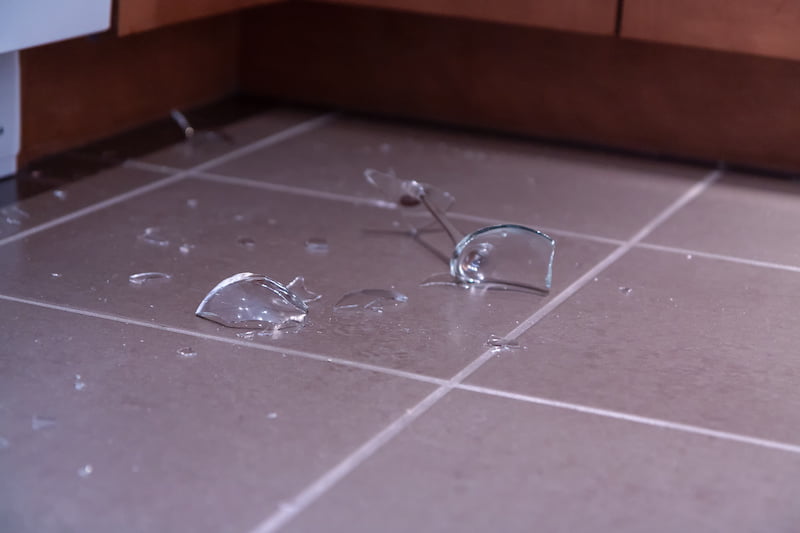 broken wine glass on kitchen floor