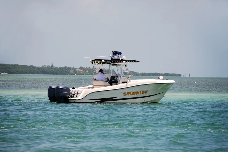 sheriff patrolling the waters in his police boat.