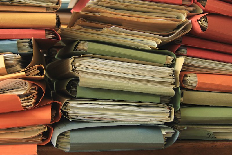 stacked files in an office, old folders.