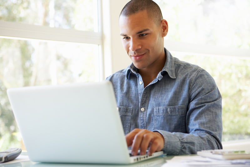 young man using laptop at home