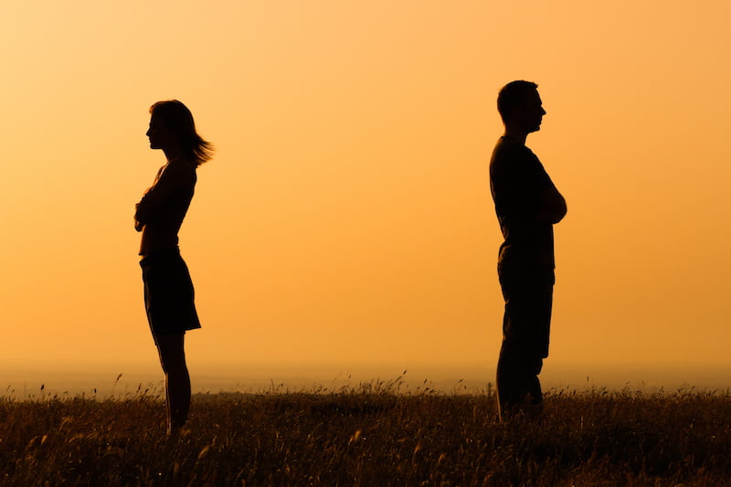 relationship difficultiesrelationship difficulties, couple facing away from each other at sunset.