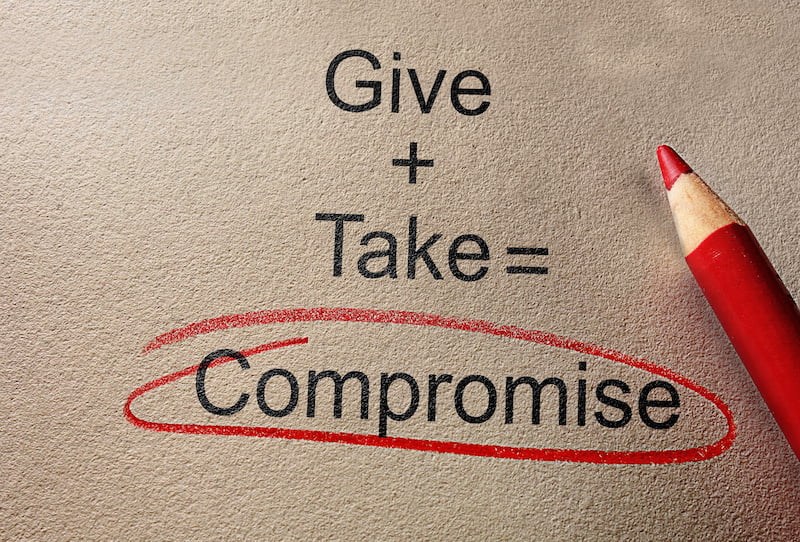 give and take compromise text on paper with pencil