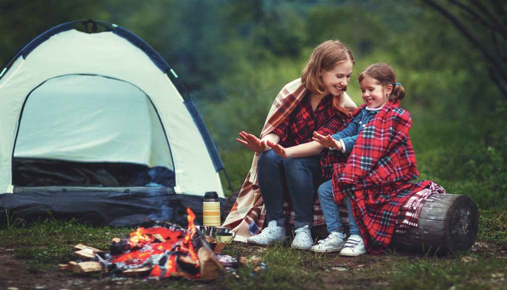 mother and daughter camping outside with tent, custody concept.
