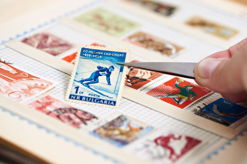 postage stamp with skier on album close-up