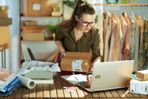 small business concept - woman shipping products out of her office.